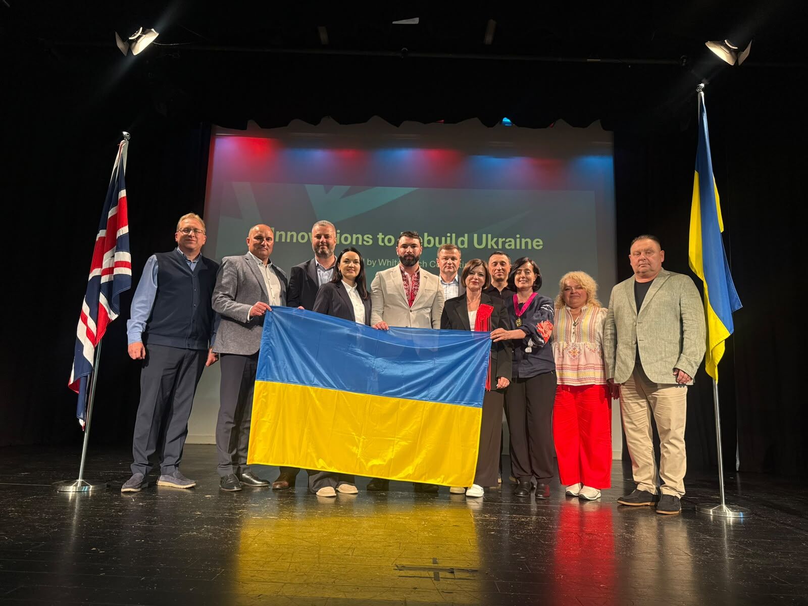 Delegation on stage with the Ukrainian flag at the U-Nation Innovation Conference